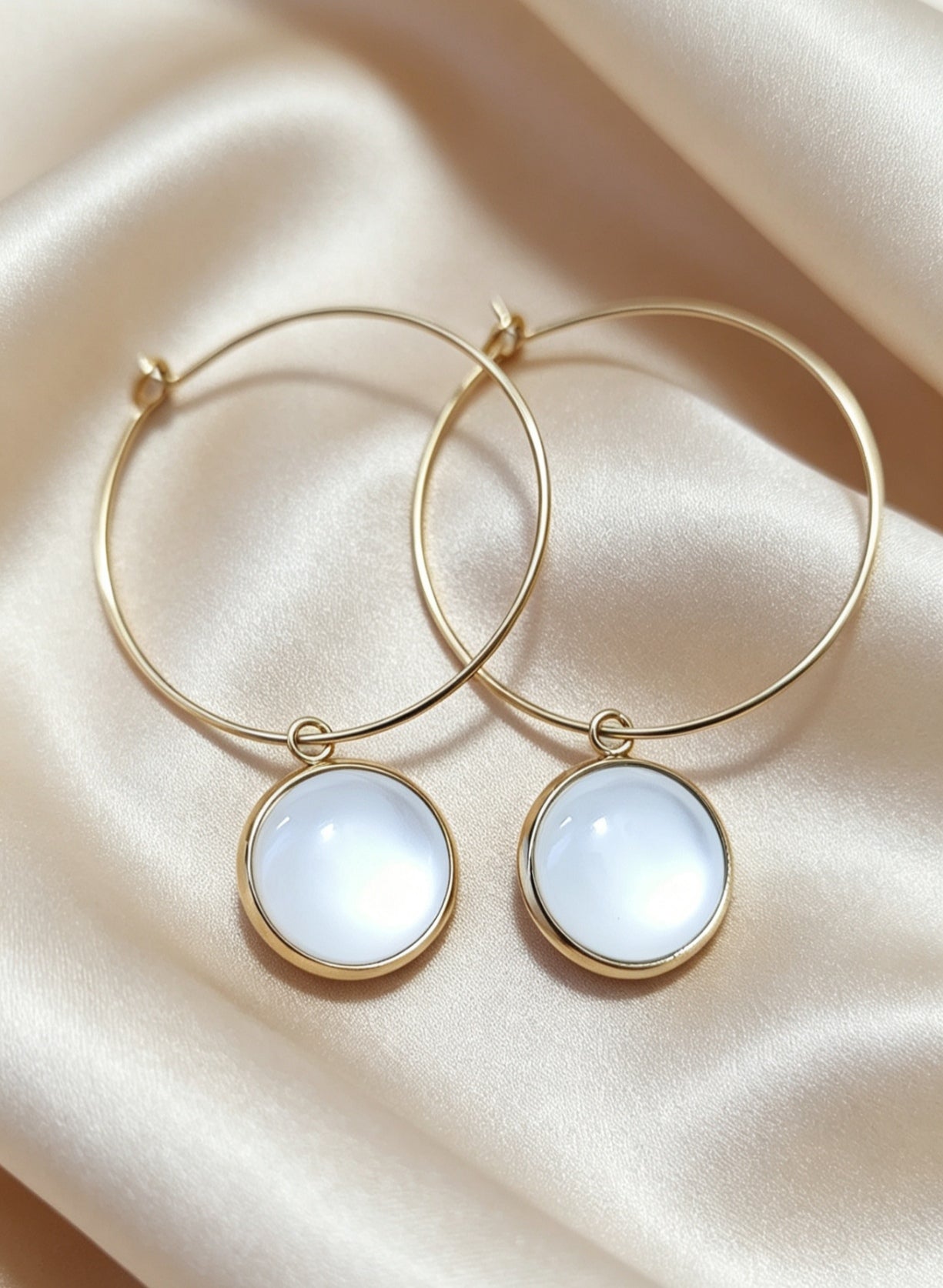 Hoop Earrings with round charm in gold tone