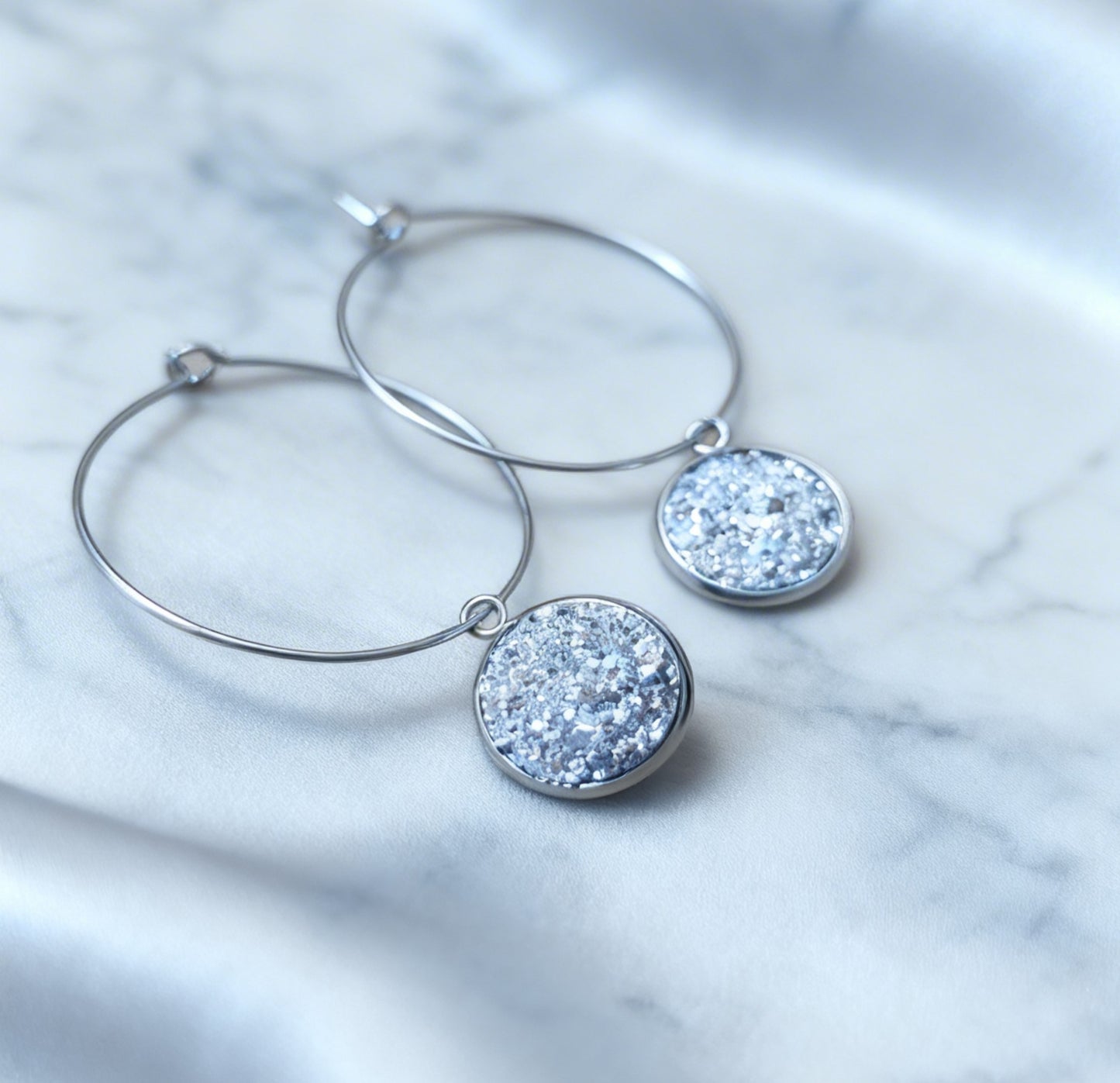 Hoop Earrings with round charm in silver tone